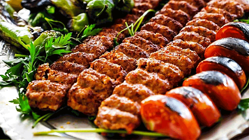 Ingredients 🥩 | <p dir="ltr"><span style="white-space: pre-wrap;">- 1 kg of ground meat (a mix of beef and lamb is traditional) 🥩
- 4 large onions, grated🧅
- Salt, to taste🧂
- Black pepper, to taste 🌶️
- Sumac, to taste (optional)
- Turmeric, to taste (optional) 🟡
- 4 tomatoes for grilling (optional) 🍅</span></p> | konj